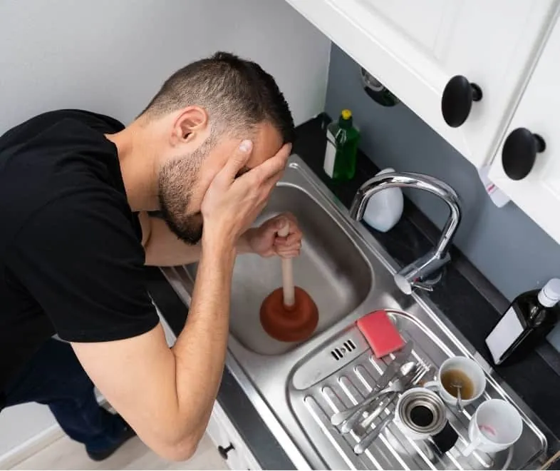 Clearing a blocked kitchen sink with a plunger